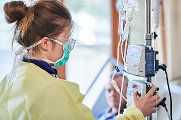 Nurse managing a healthcare machine