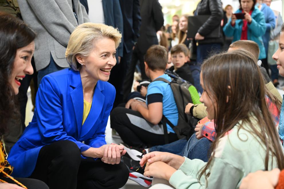 Ursula von der Leyen talking to a child