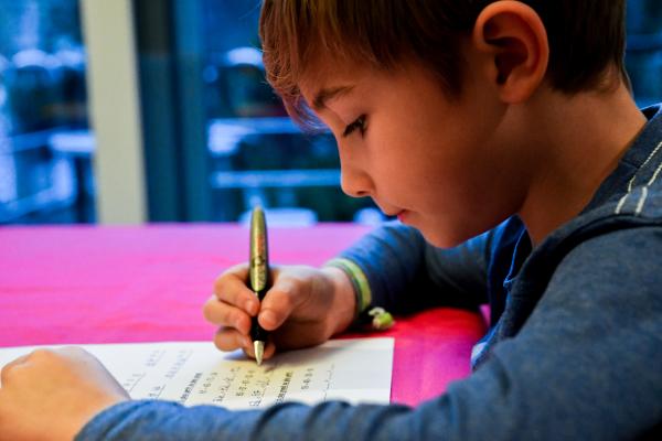 Child writing on a notebook