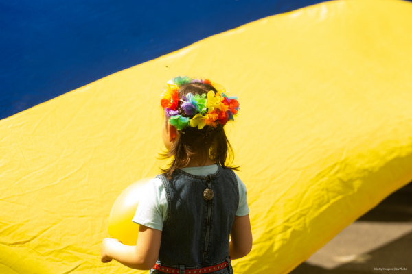 a Ukrainian girl with a flower headband, Ukraine flag in front of her