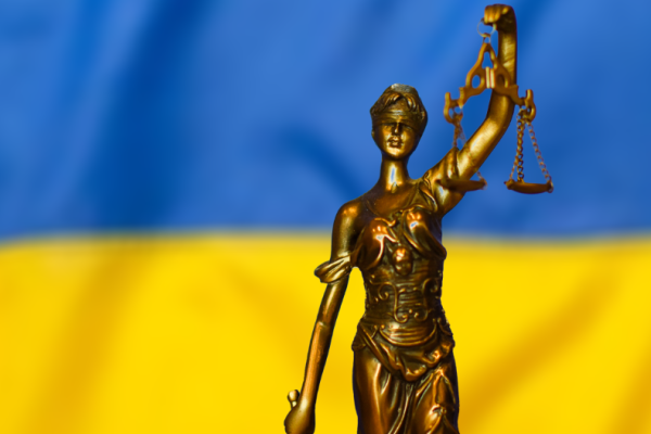 a statue representing justice and the flag of Ukraine